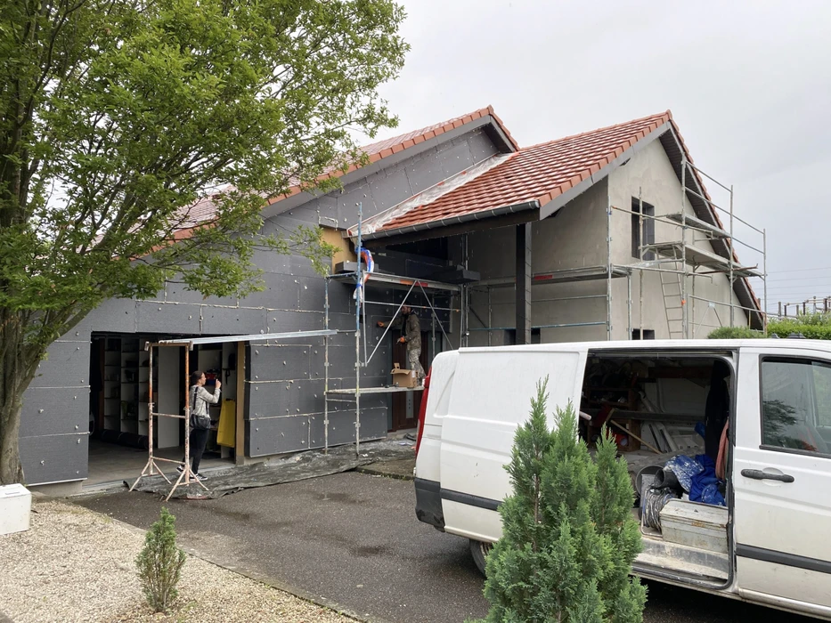 Espace de restauration d'entreprise moderne avec tables hautes et chaises, cuisine ouverte intégrée