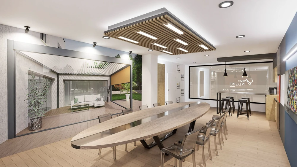 Espace de présentation commercial moderne avec cuisine ouverte équipée d'îlot central, tabourets hauts et grande table de réunion ovale