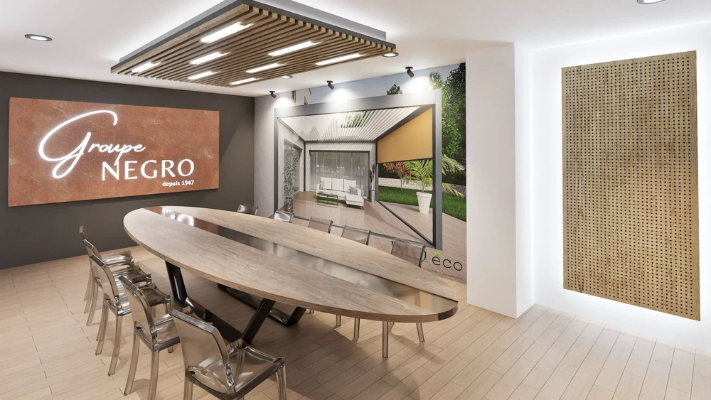 Espace de présentation commercial moderne avec cuisine ouverte équipée d'îlot central, tabourets hauts et grande table de réunion ovale