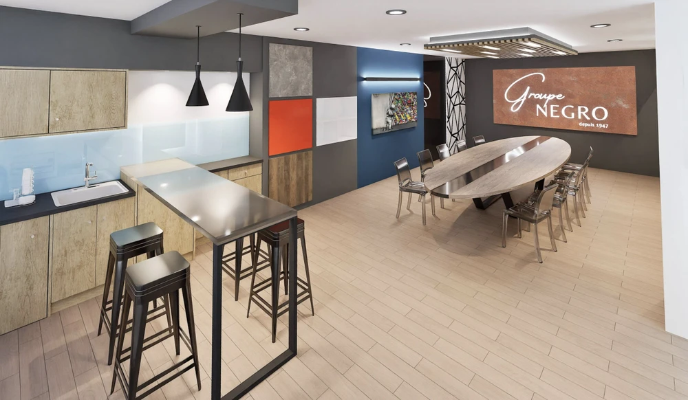 Espace de présentation commercial moderne avec cuisine ouverte équipée d'îlot central, tabourets hauts et grande table de réunion ovale